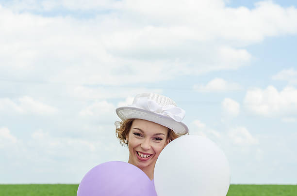 istock shy girl hiding behind balloons 578832646