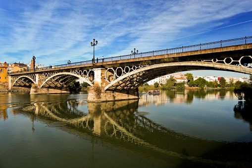 View of the Triana Bridge (official name is Bridge of Isabel II) over the Guadalquivir River in Seville, Spain