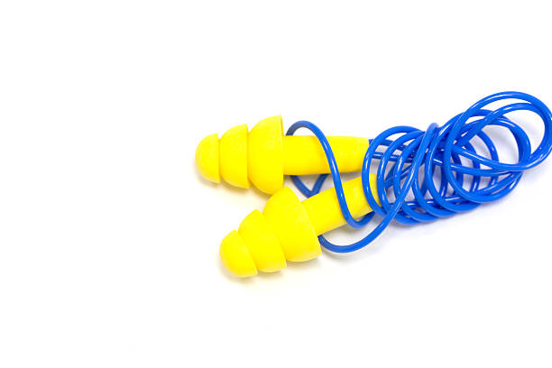 istock Yellow earplugs with blue band 578836834
