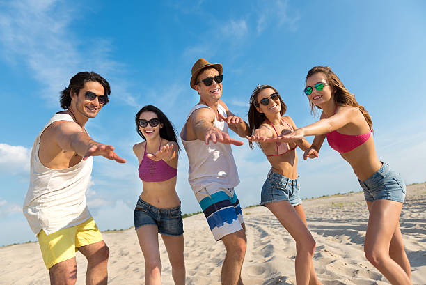 istock Cheerful smiling friends having fun on the beach 578836996