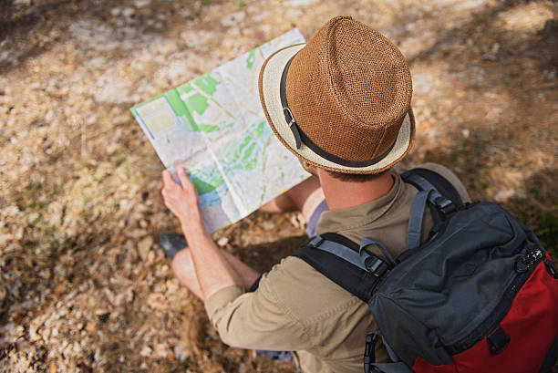 istock Cheerful man choosing touristic route 578837744