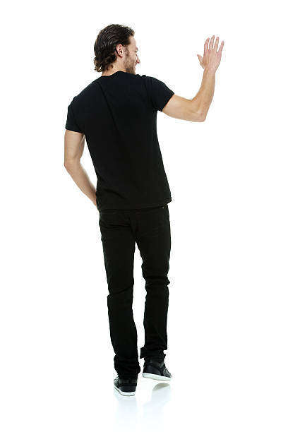 istock Rear view of man waving hand and walking 579118460