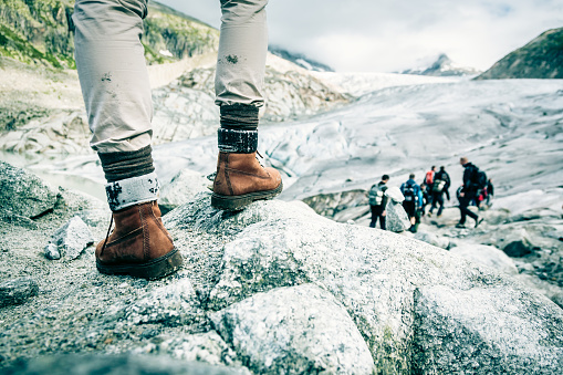 Detail Shot of Hiker's Boots. Rhone Glacier visible in the background.