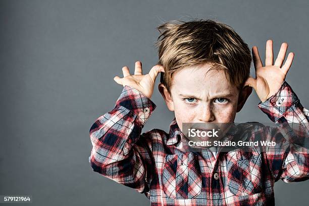 Angry Little Brat Enjoying Making A Grimace For Misbehavior Stock Photo - Download Image Now