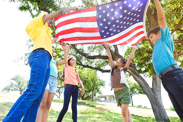 istock Group of friends wave American flag 579124612