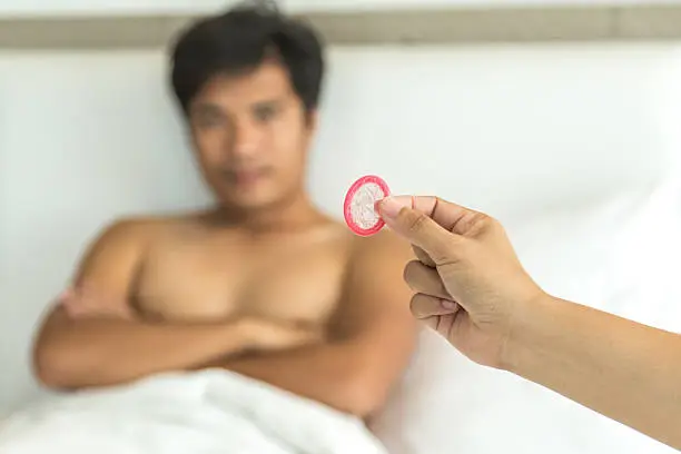 girl hand giving condoms, promote healthy lifestyle concept