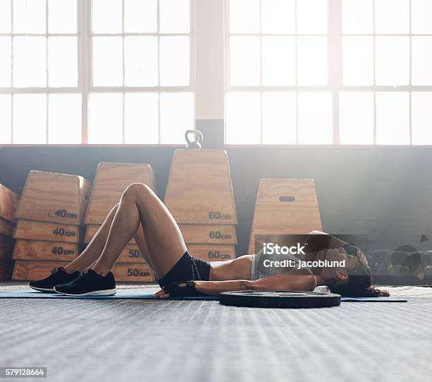 Fitness Woman Relaxing After Exercise Session Stock Photo - Download Image Now - Tired, Health Club, Women