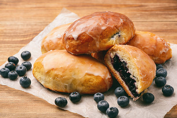 istock Blueberry filled yeast buns on brown wooden table. 579128882