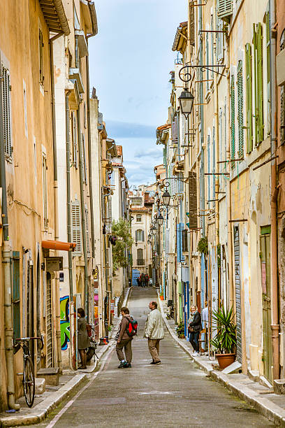 people visit the historic quarter Le Panierin Marseille Marseilles, France - March 29, 2015: people visit the historic quarter Le Panierin Marseille in South France marseille panier stock pictures, royalty-free photos & images