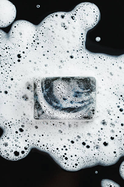 istock Coal soap in foam on black 579137456