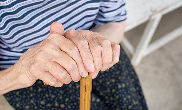 istock Old woman hands holding a walking cane 579137934
