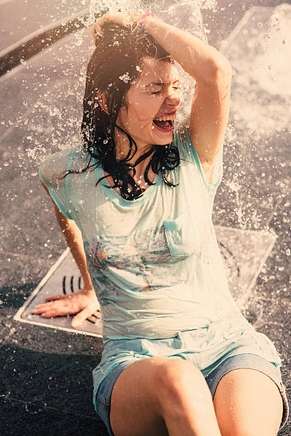 istock Girl having fun in a water fountain 579138086