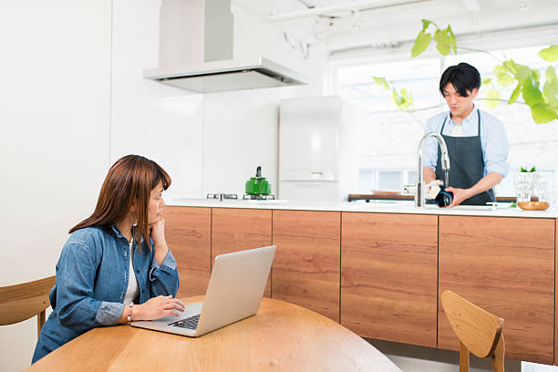 istock Woman working from home whilst husband washes dishes 579138662