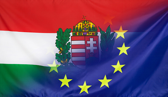 Hungary Coat of Arms and European Union relations concept with diagonally merged real fabric flags