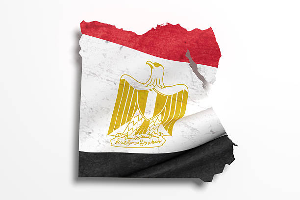 The national flag of Egypt, featuring three horizontal stripes of red, white, and black with the golden Eagle of Saladin in the center, is shown waving in the wind. The textured fabric emphasizes its motion and symbolizes national pride and heritage.