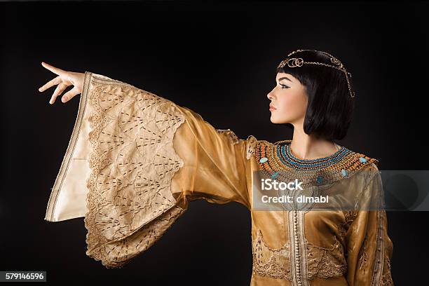 Beautiful Egyptian Woman Like Cleopatra Pointing Finger Away On Black Stock Photo - Download Image Now