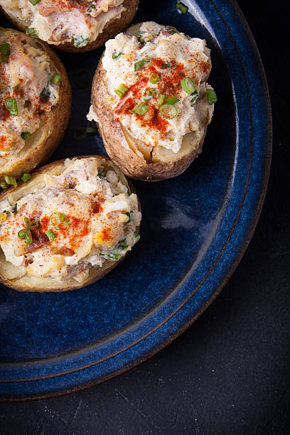 istock Baked stuffed potatoes with bacon, eggs and chives 579149448