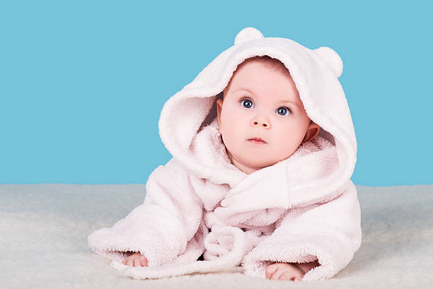 istock cute baby lying on blanket in pink bathrobe 579149538