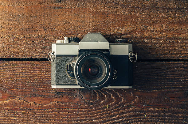 istock Vintage camera on wooden background 579149954