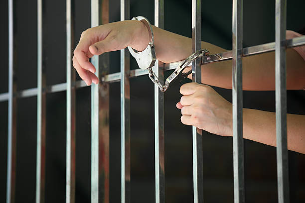 istock hand of prisoner in jail 579150362