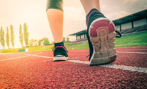 istock Runner or sprinter is running in stadium at evening. 579150390
