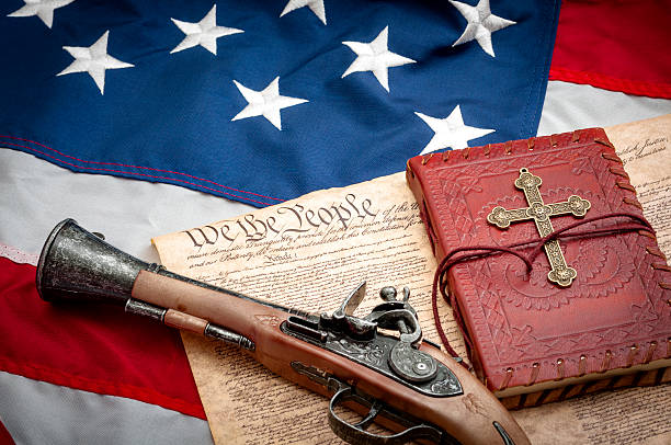 american flag, constitution, flintlock pistol, red bible and gold cross - bible american flag flag old fashioned imagens e fotografias de stock