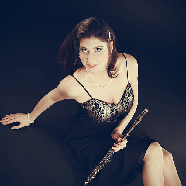 istock Elegant woman with flute instrument. 579154840