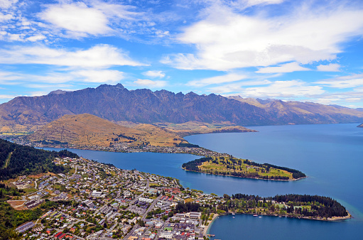 Scenic view of Queenstown and surrounding rugged mountain range (The Remarkables) on the shores of the glacial Lake Wakatipu, New Zealand