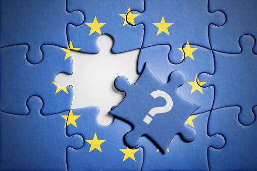 Who is next for accession to the European Union, concept puzzle. Flag of European Union on puzzle in background, with one blank place and one piece with question mark in front. Studio shot. Horizontal orientation.
