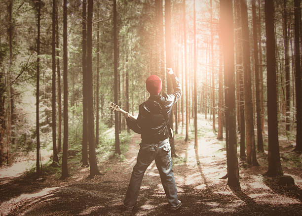 istock musician playing guitar in the forest for ecology concept 579156166