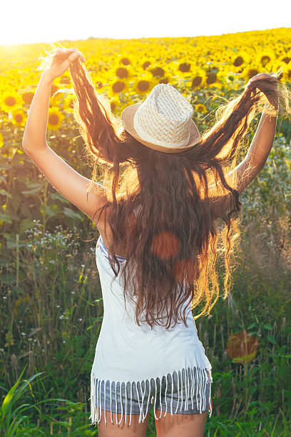 istock Sunset sunflower / Young woman watching the sunset 579156238