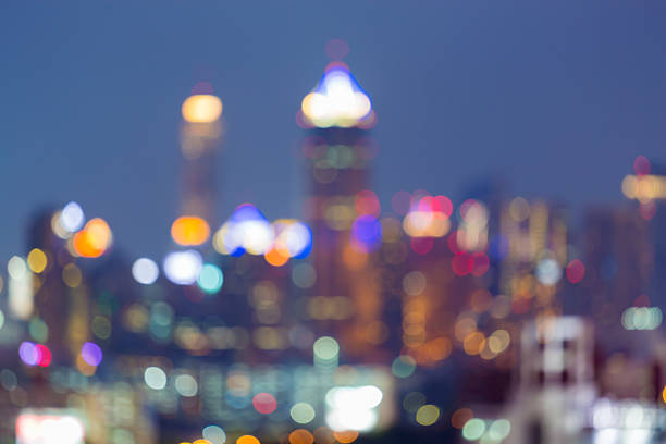 istock Blurred multiple colour lights night view, city office building background 579156252