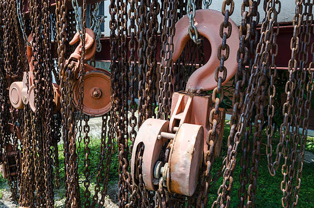 istock Old rusty metal hoist chain and pulley 579157526