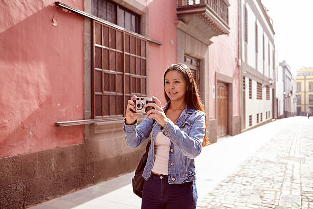 istock Pretty young girl aiming to take a picture 579159910