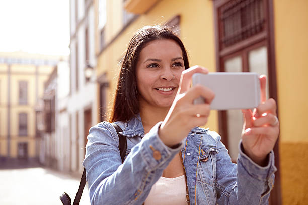 istock Pretty young lady looking up to take a picture 579159974
