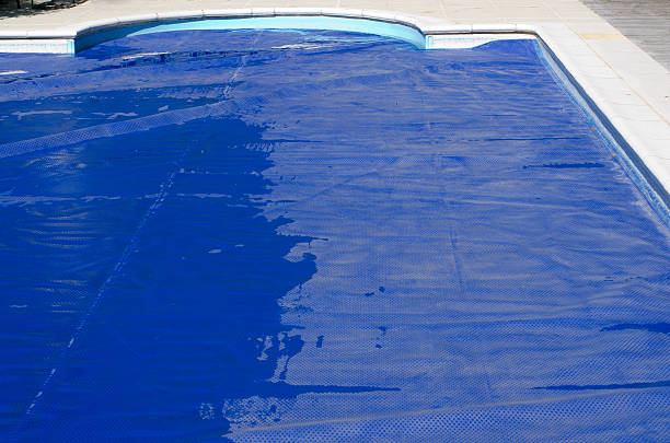 Swimming pool cover on a domestic swimming pool stock photo