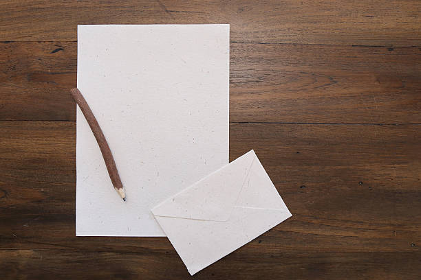 istock pencil with blank  paper on old wood table 579160944
