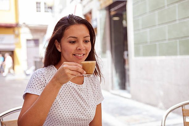 istock Happily smiling young girl drinking coffee 579161516