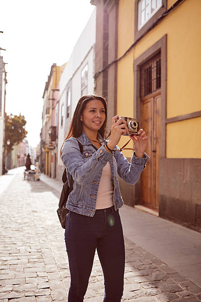 istock Pretty young girl taking a picture with a camera 579162312