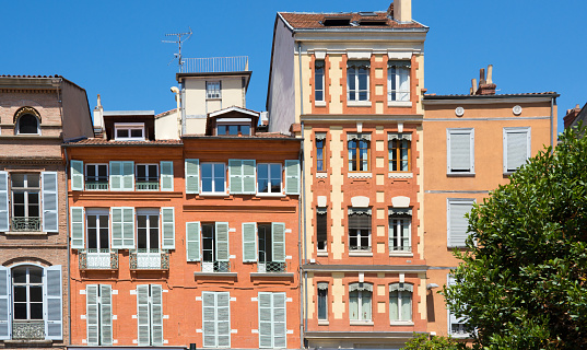 Facades of buildings on Saint-Etienne square in Toulouse, France