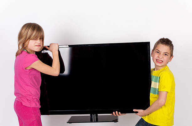 istock Kids carrying a TV 579218450