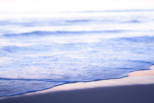 Abstract toned horizontal photo of late afternoon sun reflection on sandy beach. Actual tilt/shift lens used to exaggerate background blur.