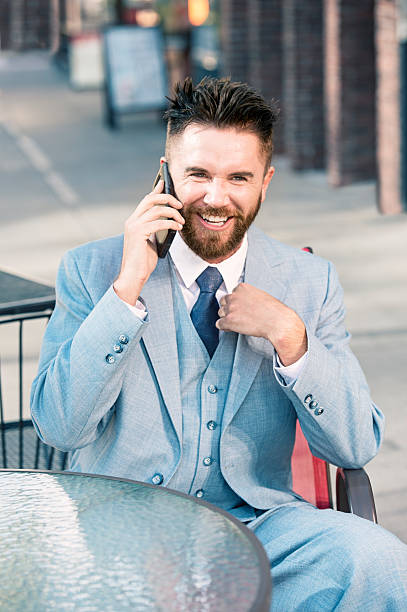 istock Businessman At A Sidewalk Cafe Talking On His Cell Phone 579219678