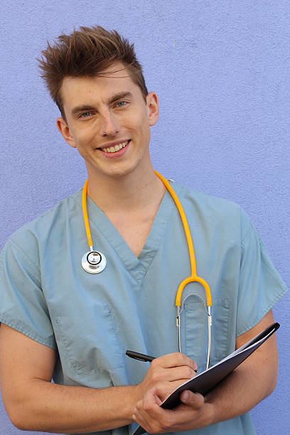 istock Young male nurse with a clipboard 579219834