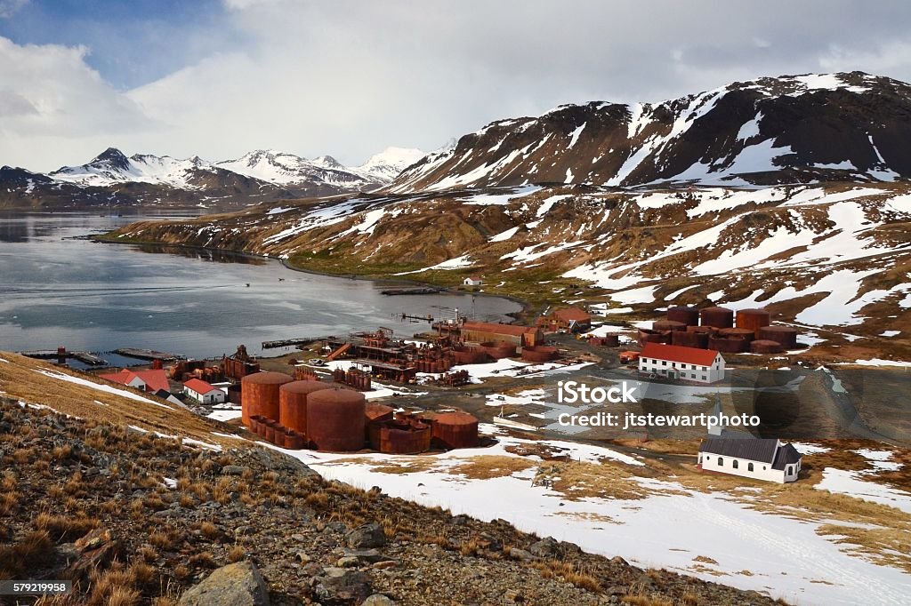 Grytviken Whaling Station A springtime view from above of Grytviken and the remains of the whaling station including the church, soccer field, storage tanks and other historic buildings in the town on South Georgia. South Georgia Island Stock Photo