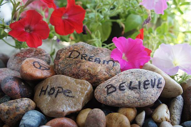 istock Peace, Dream, Hope & Believe Written on River Rocks 579220316