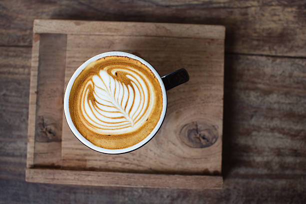 istock Hot cappuccino in black ceramic cup 579221586