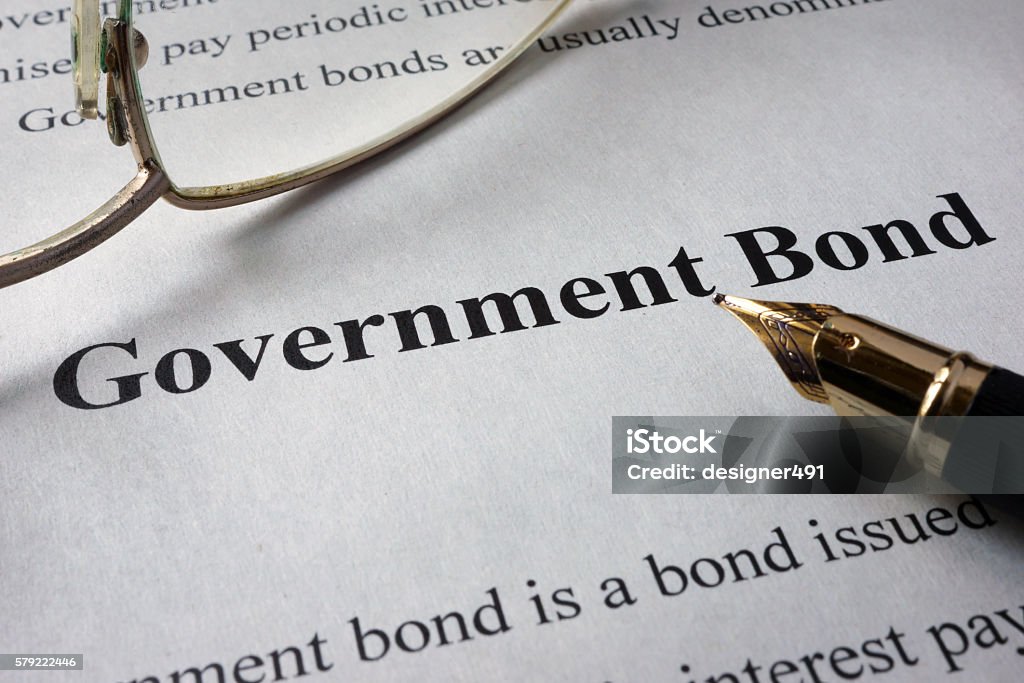 Page of newspaper with words government bonds. Page of newspaper with words government bonds. Trading concept. Government Bond Stock Photo