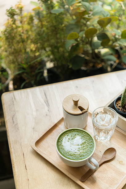 istock Hot green tea set on a wooden table in coffeshop 579224460