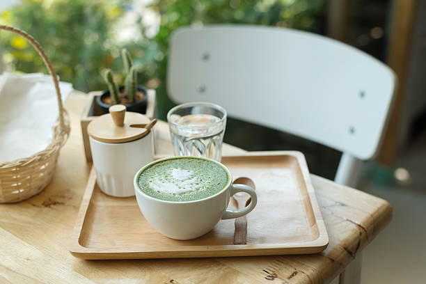istock Hot green tea set on a wooden table in coffeshop 579224642